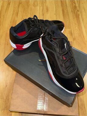 Air Jordan 11 CMFT Low Youth Black Patent Sneakers with Red & White Accent